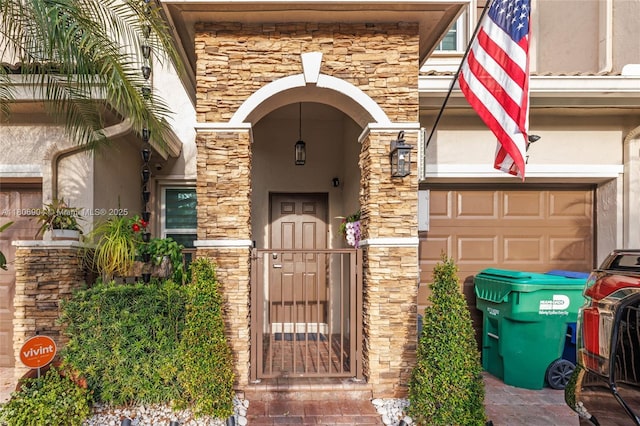 22607 SW 89th Pl, Cutler Bay, FL 33190 - doorway to property with stucco siding, stone siding, and an attached garage