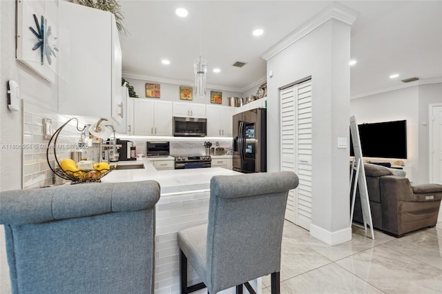 22607 SW 89th Pl, Cutler Bay, FL 33190 - kitchen featuring stainless steel appliances, crown molding, decorative backsplash, a peninsula, and recessed lighting