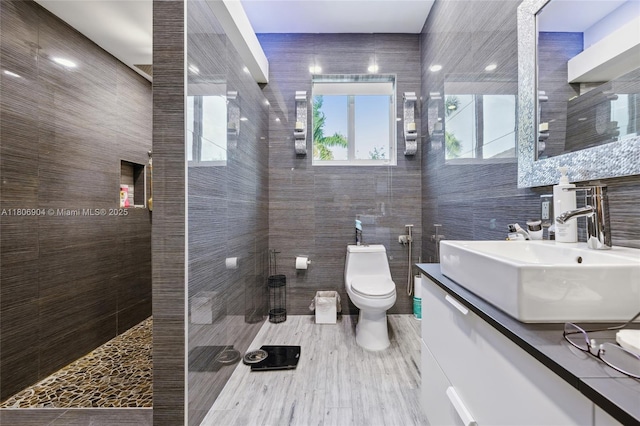22607 SW 89th Pl, Cutler Bay, FL 33190 - bathroom featuring tile walls, vanity, walk in shower, and toilet