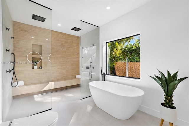 210 NE 107th St, Miami Shores, FL 33161 - bathroom featuring a walk in shower, a freestanding tub, tile patterned flooring, and recessed lighting