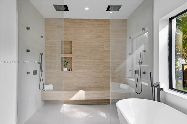 210 NE 107th St, Miami Shores, FL 33161 - full bathroom featuring tile patterned flooring, walk in shower, and a freestanding tub