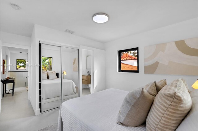 210 NE 107th St, Miami Shores, FL 33161 - bedroom with concrete flooring, a closet, and baseboards
