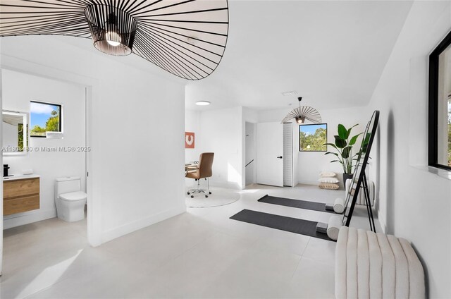 210 NE 107th St, Miami Shores, FL 33161 - hallway featuring a desk and baseboards