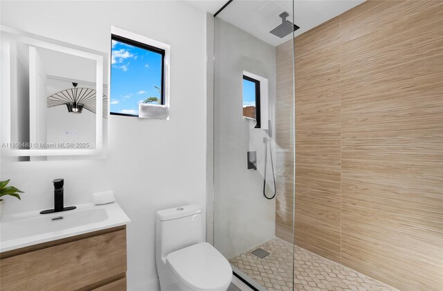 210 NE 107th St, Miami Shores, FL 33161 - full bath with toilet, tiled shower, vanity, and plenty of natural light