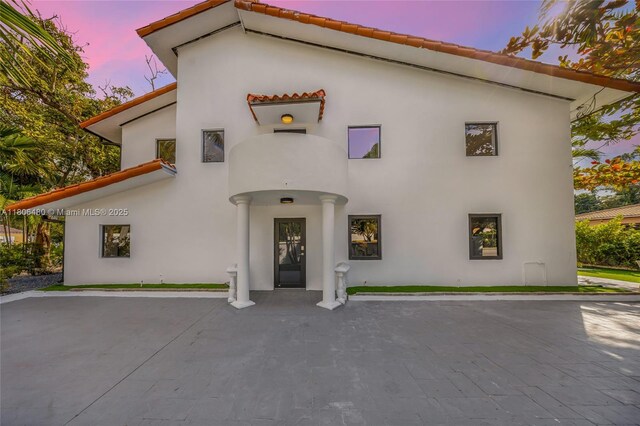 210 NE 107th St, Miami Shores, FL 33161 - view of front of property with a tile roof and stucco siding