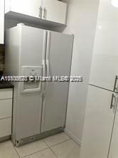 9320 Fontainebleau Blvd Unit 215, Miami, FL 33172 - kitchen with stainless steel fridge, light tile patterned floors, and dark countertops
