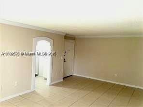 9320 Fontainebleau Blvd Unit 215, Miami, FL 33172 - unfurnished room featuring arched walkways, baseboards, light tile patterned floors, and crown molding