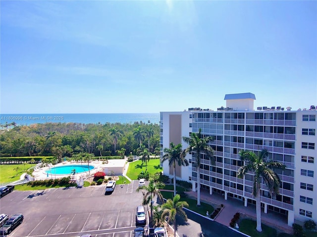 3 Bluebill Ave Unit 211, Naples, FL 34108 - view of property featuring uncovered parking and a water view