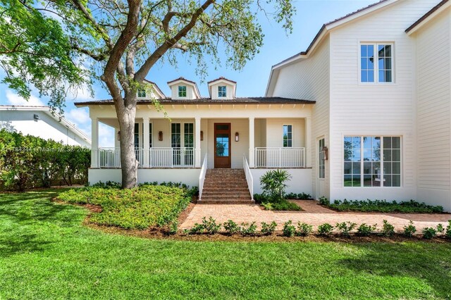 1051 San Pedro Ave, Coral Gables, FL 33156 - view of front of house with a porch, a front yard, and stairway
