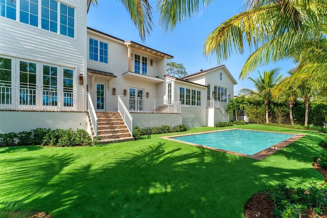 1051 San Pedro Ave, Coral Gables, FL 33156 - rear view of house featuring stairway, a yard, and an outdoor pool