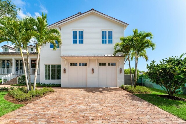 1051 San Pedro Ave, Coral Gables, FL 33156 - view of front of home with decorative driveway and an attached garage