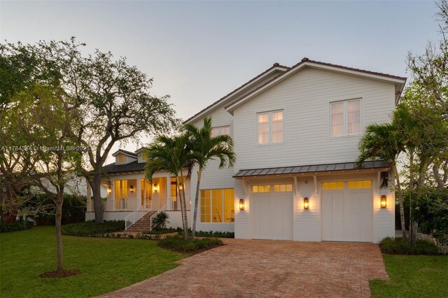 1051 San Pedro Ave, Coral Gables, FL 33156 - view of front facade featuring covered porch, decorative driveway, a front yard, and an attached garage