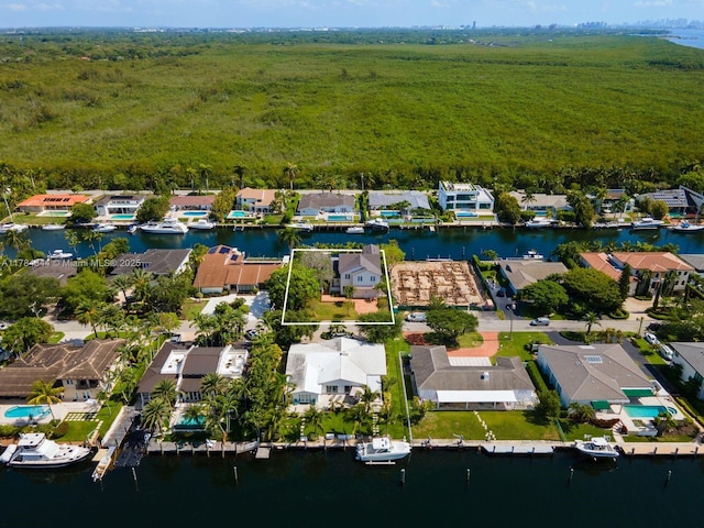 1051 San Pedro Ave, Coral Gables, FL 33156 - aerial overview of property's location with nearby suburban area, a nearby body of water, a forest, and property parcel outlined