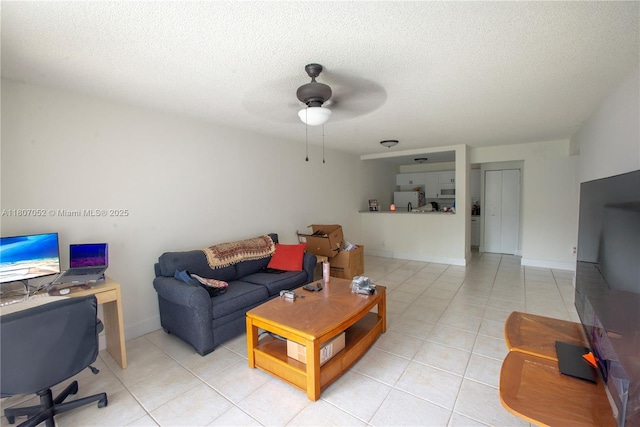 11201 SW 13th St Unit 101, Pembroke Pines, FL 33025 - living area with an office area, light tile patterned floors, a ceiling fan, a textured ceiling, and baseboards