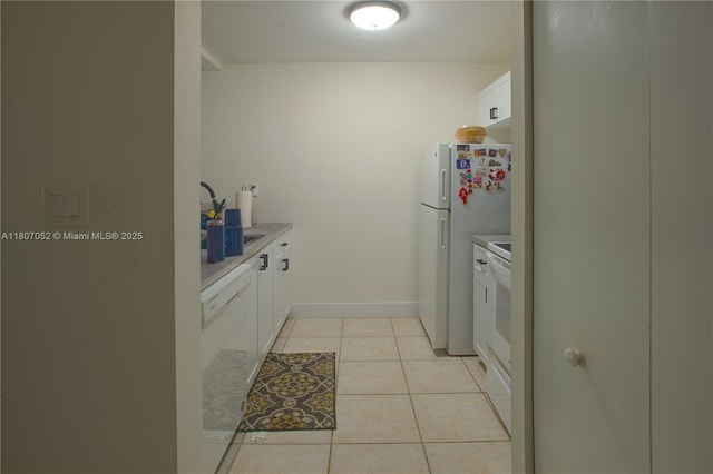 11201 SW 13th St Unit 101, Pembroke Pines, FL 33025 - kitchen featuring a sink, white appliances, white cabinets, and light countertops