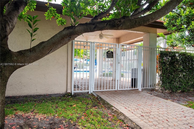 11201 SW 13th St Unit 101, Pembroke Pines, FL 33025 - view of exterior entry featuring stucco siding and a ceiling fan