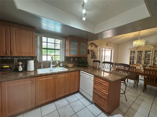 10075 NW 129th Ter, Hialeah Gardens, FL 33018 - kitchen featuring a sink, dishwasher, a tray ceiling, a breakfast bar, and a peninsula