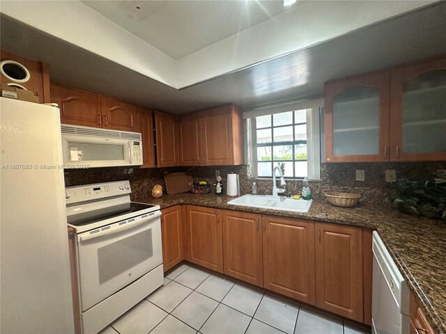 10075 NW 129th Ter, Hialeah Gardens, FL 33018 - kitchen with white appliances, a sink, tasteful backsplash, light tile patterned floors, and glass insert cabinets