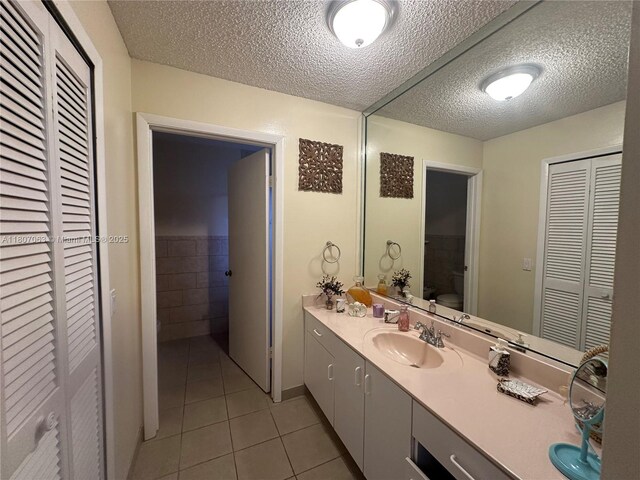 10075 NW 129th Ter, Hialeah Gardens, FL 33018 - full bath featuring a closet, tile patterned floors, toilet, a textured ceiling, and vanity