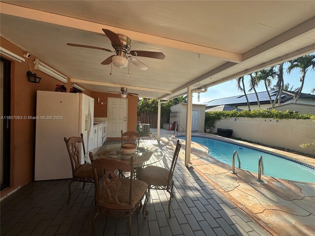 10075 NW 129th Ter, Hialeah Gardens, FL 33018 - fenced backyard with a patio area, ceiling fan, and outdoor dining area