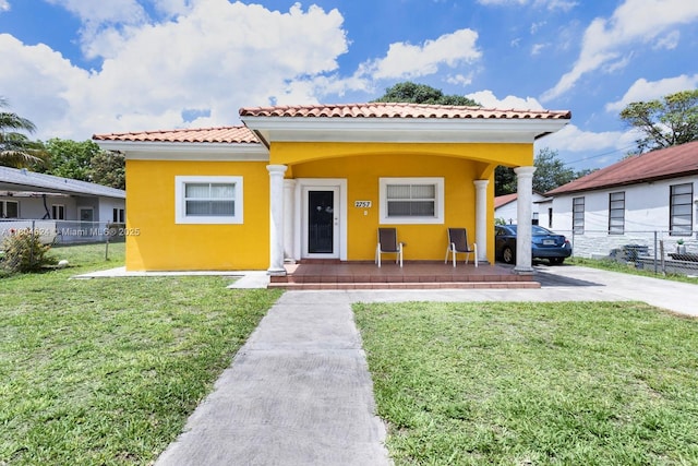 2757 NW 29th St, Miami, FL 33142 - view of front facade featuring stucco siding, covered porch, and a tiled roof