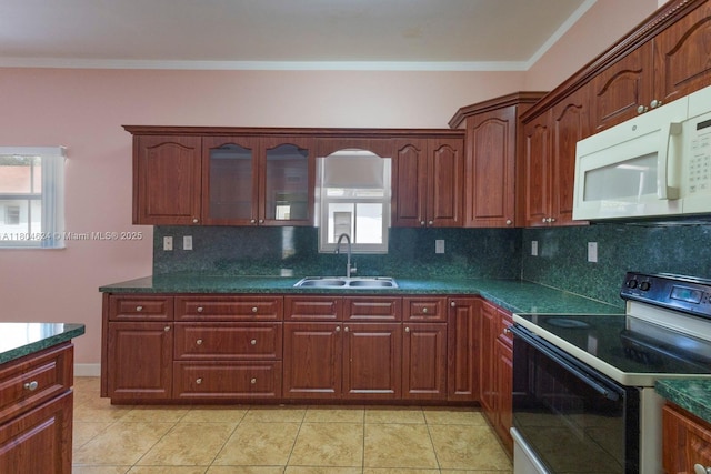 2757 NW 29th St, Miami, FL 33142 - kitchen with black electric range, a sink, white microwave, decorative backsplash, and dark countertops
