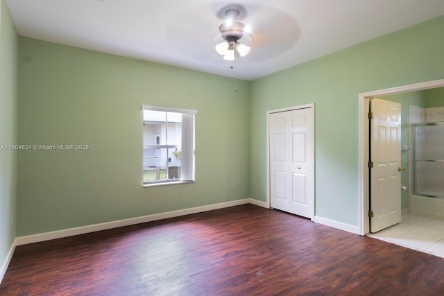 2757 NW 29th St, Miami, FL 33142 - unfurnished bedroom featuring wood finished floors, baseboards, a closet, and a ceiling fan