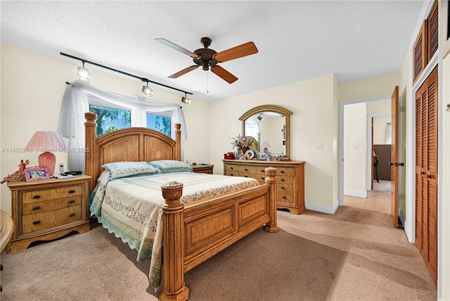 43 NW 109th Ct, Miami, FL 33172 - bedroom featuring light carpet, multiple windows, a textured ceiling, a closet, and track lighting