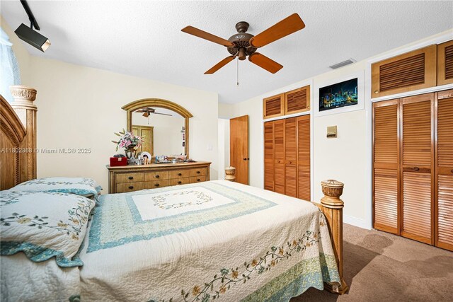 43 NW 109th Ct, Miami, FL 33172 - bedroom with two closets, carpet floors, a ceiling fan, and a textured ceiling
