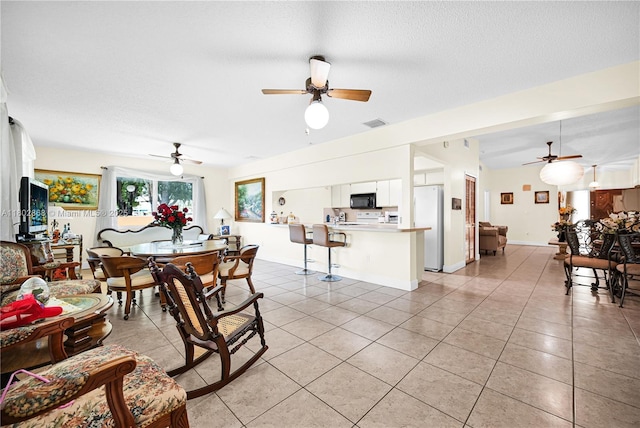 43 NW 109th Ct, Miami, FL 33172 - dining room featuring a ceiling fan, light tile patterned flooring, a textured ceiling, and baseboards