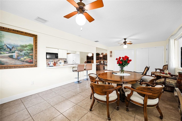 43 NW 109th Ct, Miami, FL 33172 - dining area with a ceiling fan, light tile patterned floors, baseboards, and a textured ceiling