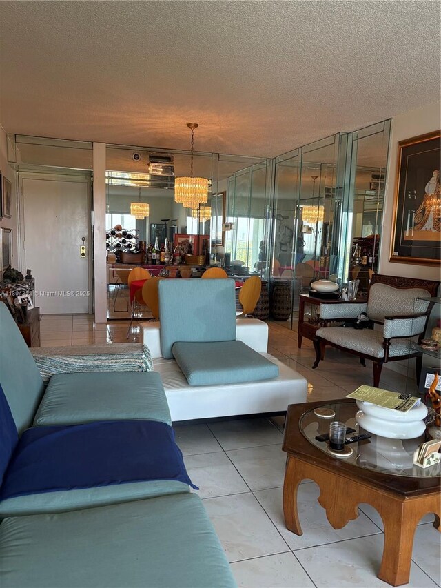 3850 Washington St Unit 1011, Hollywood, FL 33021 - living area featuring a textured ceiling, tile patterned floors, and a chandelier