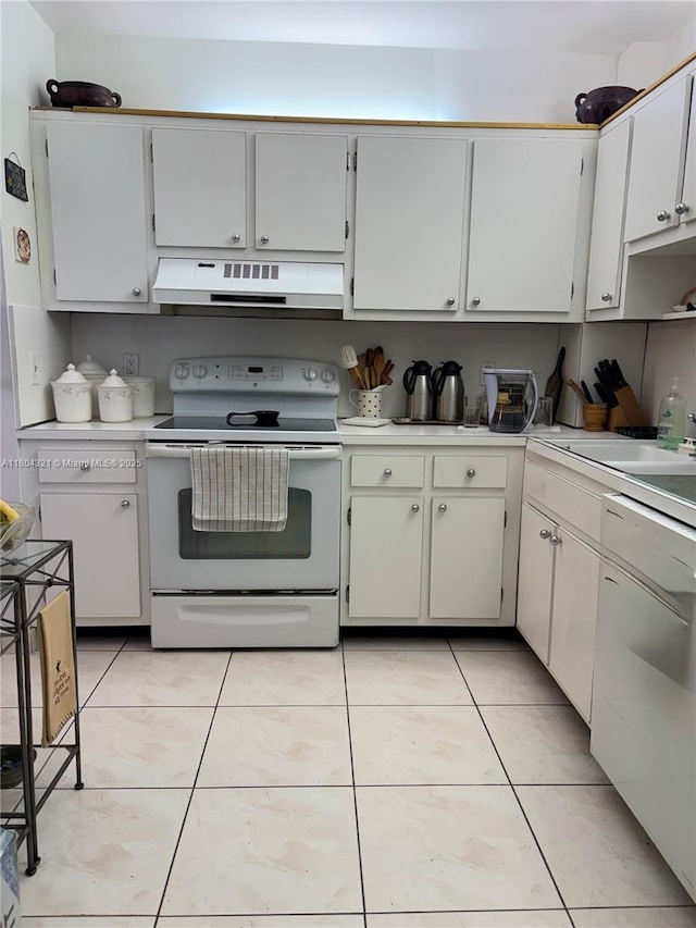 3850 Washington St Unit 1011, Hollywood, FL 33021 - kitchen featuring white appliances, under cabinet range hood, light countertops, and light tile patterned flooring