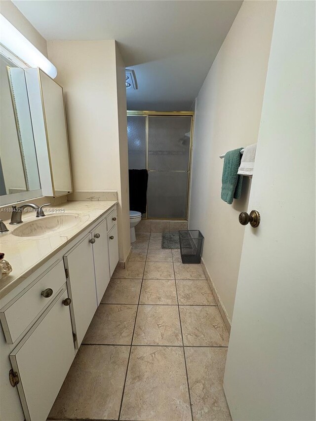 3850 Washington St Unit 1011, Hollywood, FL 33021 - bathroom with a shower stall, toilet, vanity, tile patterned floors, and baseboards