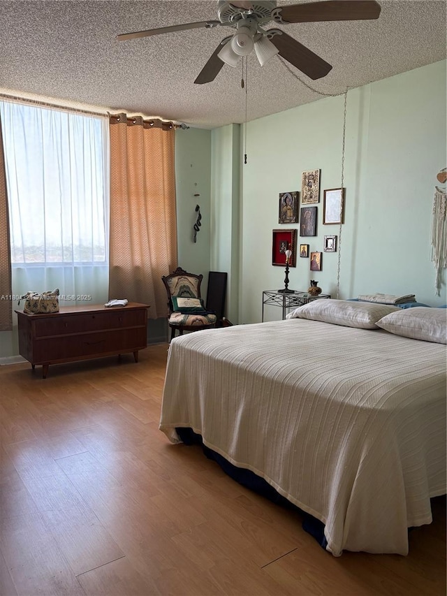 3850 Washington St Unit 1011, Hollywood, FL 33021 - bedroom with wood finished floors, a textured ceiling, and a ceiling fan