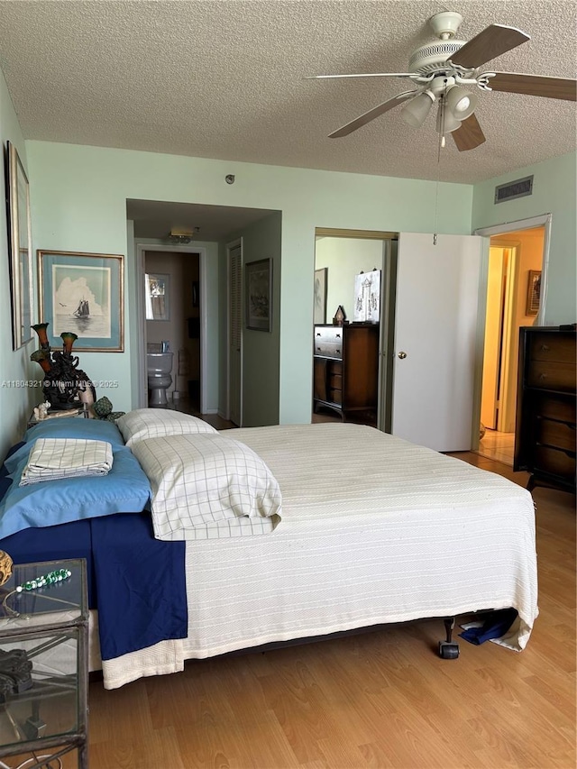3850 Washington St Unit 1011, Hollywood, FL 33021 - bedroom with wood finished floors, a textured ceiling, and a ceiling fan