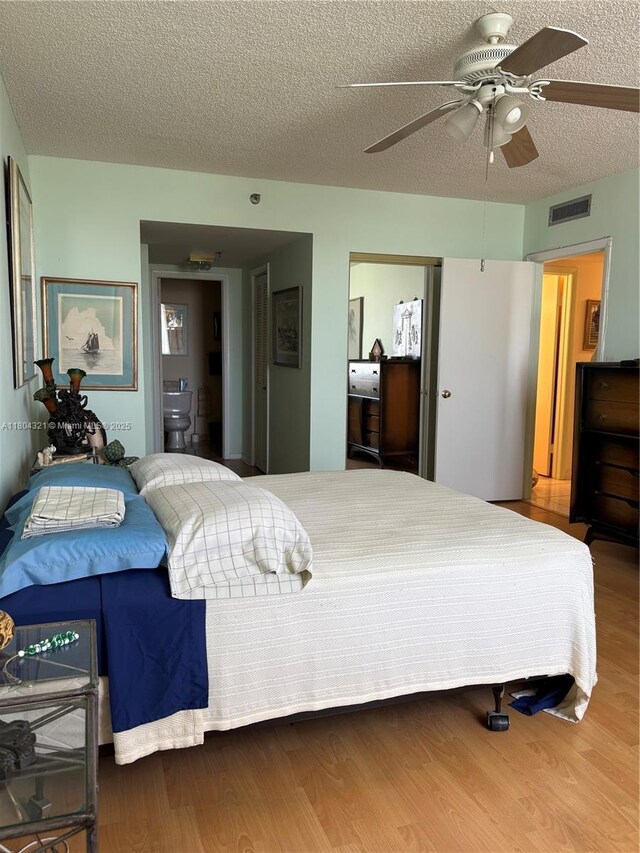 3850 Washington St Unit 1011, Hollywood, FL 33021 - bedroom featuring wood finished floors, a textured ceiling, and ceiling fan