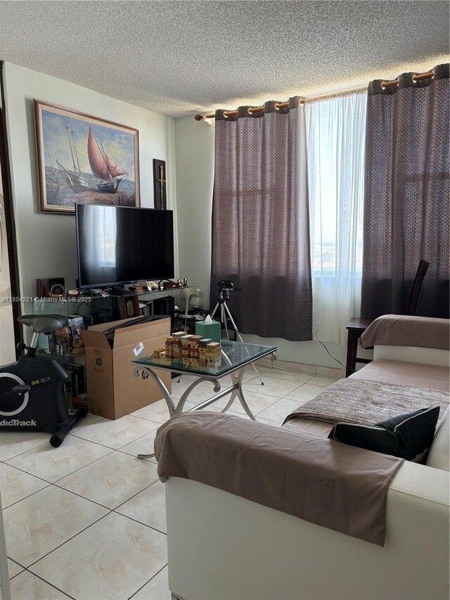 3850 Washington St Unit 1011, Hollywood, FL 33021 - living room with a textured ceiling and light tile patterned floors