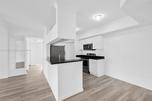 17150 N Bay Rd Unit 2814, Sunny Isles Beach, FL 33160 - kitchen featuring stainless steel appliances, dark countertops, white cabinetry, light wood-style flooring, and ornamental molding