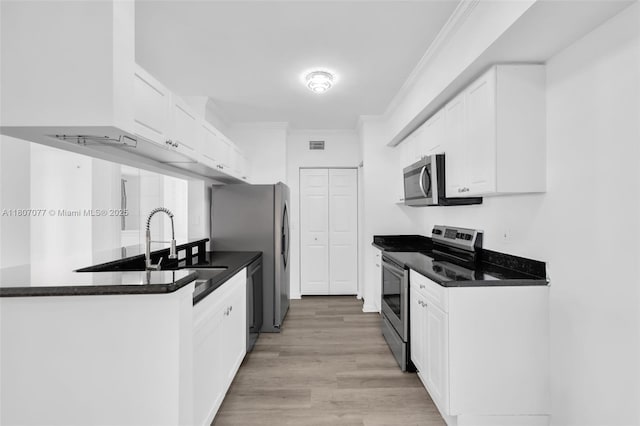 17150 N Bay Rd Unit 2814, Sunny Isles Beach, FL 33160 - kitchen with stainless steel appliances, white cabinets, crown molding, and dark countertops