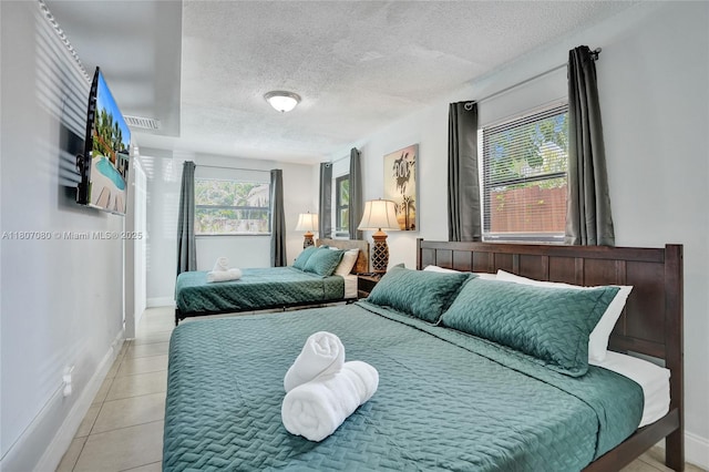 7531 Simms St, Hollywood, FL 33024 - bedroom featuring baseboards, a textured ceiling, and light tile patterned flooring