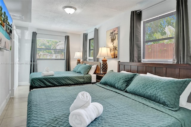7531 Simms St, Hollywood, FL 33024 - tiled bedroom with multiple windows, a textured ceiling, and baseboards