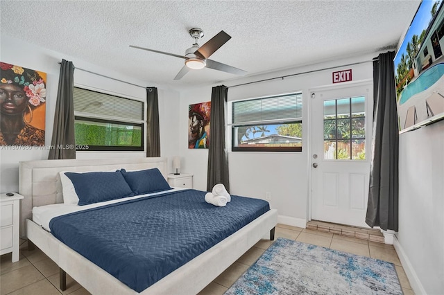 7531 Simms St, Hollywood, FL 33024 - bedroom featuring tile patterned floors, a textured ceiling, ceiling fan, and baseboards