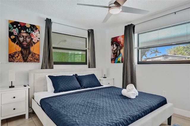 7531 Simms St, Hollywood, FL 33024 - bedroom featuring light tile patterned floors, a textured ceiling, and a ceiling fan