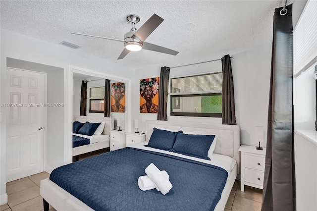 7531 Simms St, Hollywood, FL 33024 - bedroom with light tile patterned floors, ceiling fan, and a textured ceiling