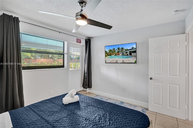 7531 Simms St, Hollywood, FL 33024 - unfurnished bedroom featuring a textured ceiling, a ceiling fan, light tile patterned floors, and baseboards