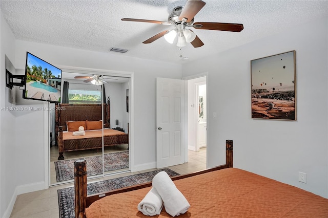 7531 Simms St, Hollywood, FL 33024 - bedroom with a textured ceiling, light tile patterned floors, ceiling fan, a closet, and baseboards