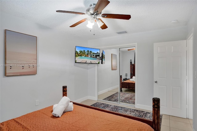 7531 Simms St, Hollywood, FL 33024 - tiled bedroom with a textured ceiling, a closet, and a ceiling fan