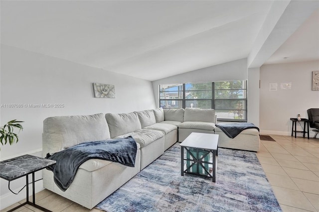 7531 Simms St, Hollywood, FL 33024 - living area with tile patterned floors, vaulted ceiling, and baseboards