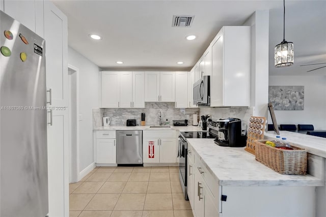 7531 Simms St, Hollywood, FL 33024 - kitchen featuring appliances with stainless steel finishes, a sink, backsplash, white cabinets, and light stone countertops